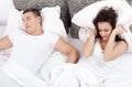 Snoring man and young woman. Couple sleeping in bed. Royalty Free Stock Photo