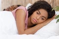 Close up of annoyed woman laying next to snoring husband Royalty Free Stock Photo