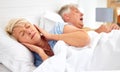 Snoring, problem and woman with frustrated with noise, sound or husband sleeping in bed with wife. Elderly, couple and Royalty Free Stock Photo