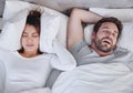 Snoring, stress and above angry woman with sleeping man in bed, unhappy and frustrated, insomnia and crisis. Bedroom Royalty Free Stock Photo