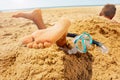 Snorkel, mask and boy feet buried in sand beach Royalty Free Stock Photo