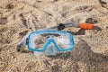 Snorkel mask with tube on sandy beach Royalty Free Stock Photo