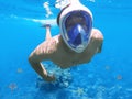 Snorkeler and coral reef, snorkeling man in full face mask Royalty Free Stock Photo