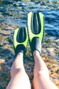 Snorkeler relaxing on a beach. Have a rest. Fins. Beach vacation snorkel. Relaxing on summer holidays lying down in water after sn Royalty Free Stock Photo