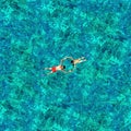 Snorkeling couple in the sea water. View from a drone