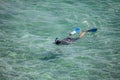 Snorkeling diver looking for fish in the warm waters