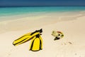 Snorkeling equipment mask, snorkel and fins on sand at beach Royalty Free Stock Photo