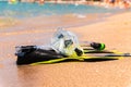 Snorkeling equipment set snorkel mask fins lie on golden sand by the seashore Royalty Free Stock Photo