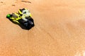 Snorkeling equipment set snorkel mask fins lie on golden sand by the seashore Royalty Free Stock Photo