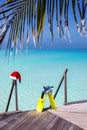 Snorkeling gear and christmas hat on a wooden jetty