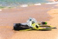 Snorkeling kit. Fins, snorkel and snorkel on the golden beach of the sea or ocean. Vacation and recreation concept on Royalty Free Stock Photo