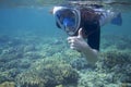 Snorkeling woman show thumb up. Snorkel in coral reef of tropical sea. Young girl in full-face snorkeling mask. Royalty Free Stock Photo