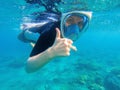 Snorkeling woman shows thumb. Snorkeling girl in full-face snorkeling mask. Royalty Free Stock Photo