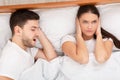 Angry Wife Trying To Sleep Near Snoring Husband At Home