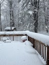 Snow accumulating on a wood deck during Noreaster