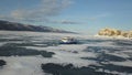 Snow air motion boat goes on big snow field of a frozen lake. Clip. Aerial view of icy surface of the Baikal lake near Royalty Free Stock Photo