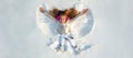Snow angel. Smiling child lying on snow with copy space. Funny kid making snow angel. Happy kid girl make snow angel Royalty Free Stock Photo