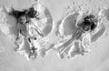 Snow angels made by a kids in the snow. Smiling children lying on snow with copy space. Funny kids making snow angel Royalty Free Stock Photo