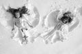 Snow angels made by a kids in the snow. Smiling children lying on snow with copy space. Funny kids making snow angel Royalty Free Stock Photo