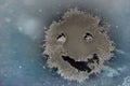 Snow background. Texture of wet snow with a cheerful smiley symbol pattern in the winter window of the car outdoors close-up. Royalty Free Stock Photo