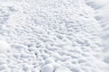 Snow background. Tubercles of the earth are covered with hoarfrost