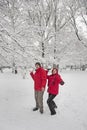 Young couple throwing snowballs