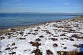 snow on the beach, blue sea after a snowfall