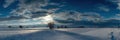 Snow-covered Landscape Under a Dramatic Sky at Sunset in Winter With Trees and Rolling Fields Royalty Free Stock Photo