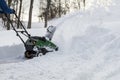 Snow blower in action clearing a residential driveway after snow storm Royalty Free Stock Photo