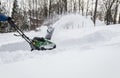 Snow blower in action clearing a residential driveway after snow storm Royalty Free Stock Photo