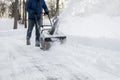 Snow blower in action clearing a residential driveway after snow storm Royalty Free Stock Photo