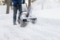 Snow blower in action clearing a residential driveway after snow storm Royalty Free Stock Photo