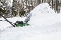 Snow blower in action clearing a residential driveway after snow storm Royalty Free Stock Photo