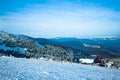 Snow blower machine working in ski resort with forest and mountains at background Royalty Free Stock Photo