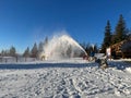 Snow blower in a ski resort on a sunny winter day Royalty Free Stock Photo