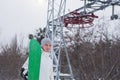 Snow boarder standing near a chair lift