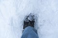 A snow boot close up shot of a ice shoe standing and walking in fresh white powder snow. the ice is clean and cold looking. The Royalty Free Stock Photo