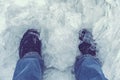 A snow boot close up shot of a ice shoe standing and walking in fresh white powder snow. the ice is clean and cold looking. The Royalty Free Stock Photo