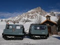 Snow bus mobile and chapel on italian Dolomites mountains - snowy winter day