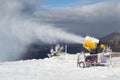 Snow cannon machine at work on a ski piste, at Azuga ski domain, Prahova Valley region, Romania
