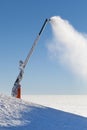 Snow cannon making artificial snow powder on a mountain ski slope Royalty Free Stock Photo