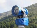 Snow cannon with mountains background in summertime . Sesto Dolomites, South Tyrol, Italy Royalty Free Stock Photo