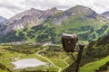 Snow cannon protected with a cover against weather conditions. Snow gun in summer season on ski slope in Alps