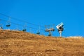 Snow Cannon or Snowmaking System and Empty Chairlift Royalty Free Stock Photo