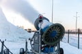 The snow cannon sprays artificial snow crystals. Artificial snow system. Snow guns. Cars make snow Royalty Free Stock Photo