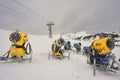 Snow canon at ski resort with mountains on background