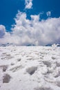 Snow cap mountains with footmarks and bright blue sly Royalty Free Stock Photo