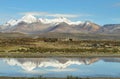 Snow capped high mountains reflected in Lake Chungara Royalty Free Stock Photo