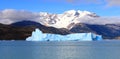 Snow capped mountain and blue iceberg in a lake. Royalty Free Stock Photo