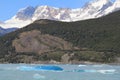 Snow capped mountain and blue iceberg in a lake. Royalty Free Stock Photo